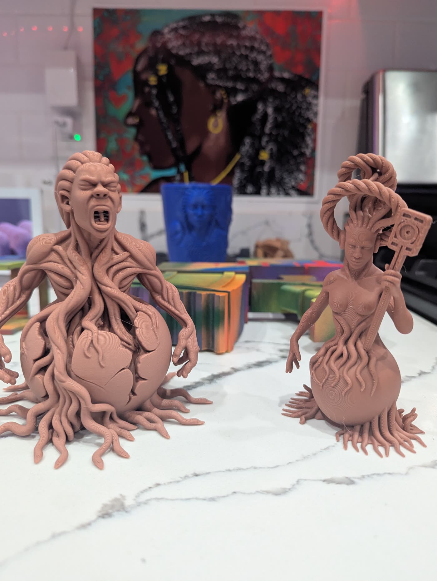 Brother and Sister sculptures with wall artwork in the Rosser Gallery studio